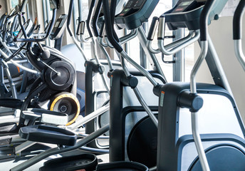 A number of cardio exercise machines - ellipsoids in a fitness center