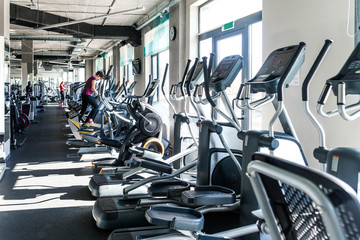 A number of cardio exercise machines - ellipsoids in a fitness center