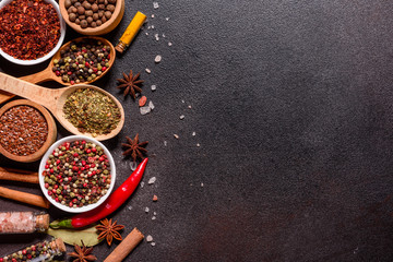 A set of spices and herbs. Indian cuisine. Pepper, salt, paprika, basil and other on a dark...