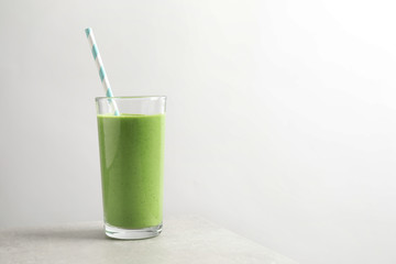 Tasty kale smoothie on light grey marble table, space for text