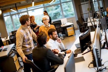 Senior businesswoman and young business people work in a modern office