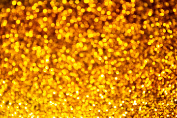 Golden sparkles bokeh on a dark background