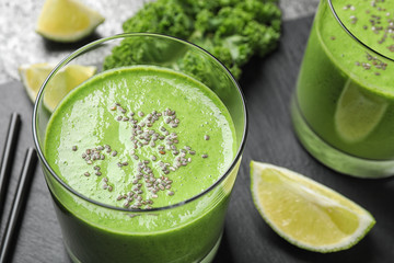 Tasty kale smoothie with chia seeds on table, closeup
