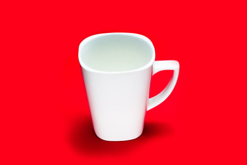 White square cup on a red background. copy space