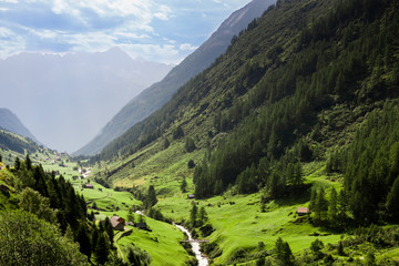 Scenery picturesque view of houses on green meadows in alps peaks mountain in Switzerland