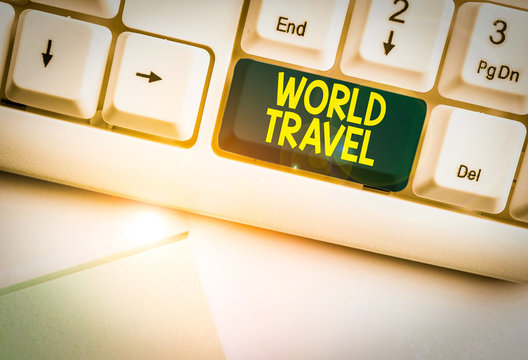 Handwriting text World Travel. Conceptual photo the movement of showing between distant geographical locations White pc keyboard with empty note paper above white background key copy space