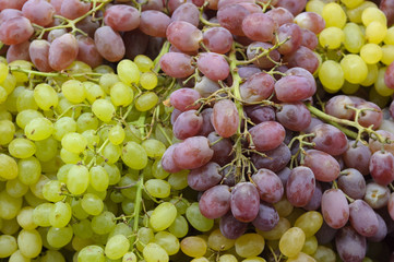 Fresh Green And Red Wine Grapes In Sale At The Market. Fruit Background.