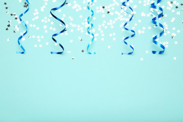 Serpentine ribbons with stars on blue background