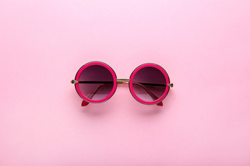 Modern sunglasses on pink background