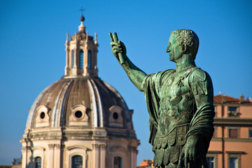 Fototapeta na wymiar a statue with the dome of a church in Rome