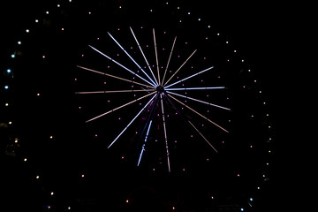 illumination on a ferris wheel at night