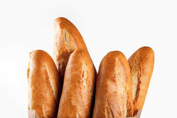Baguette bread in paper bag on white background