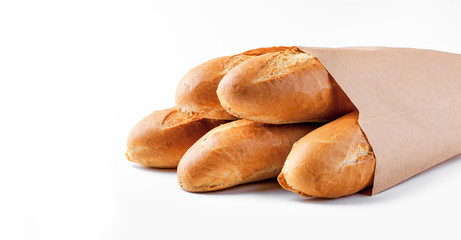 Baguette bread in paper bag on white background
