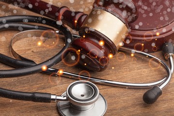 Gavel and stethoscope on wooden desk