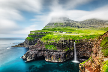 Incredible day view of Mulafossur waterfall in Gasadalur village, Vagar Island of the Faroe...