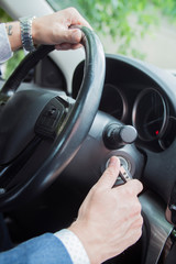 close up of the driver's hand that starts the car
