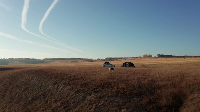 aerial drone shot of mother hug her daughter before tent and car contryside