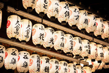 Japan,?Kyoto?Prefecture,?Kyoto?City,?Rows of lanterns glowing in Japanese temple?at night