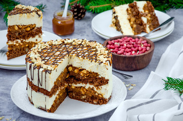 Festive layer cake with chocolate sponge cake, nougat, salted caramel and peanuts. Cake for Christmas and New Year. Horizontal orientation.