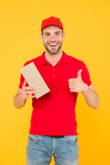 Super fast courier agent. Service delivery. Salesman career. Courier and delivery. Postman delivery worker. Man red cap yellow background. Delivering purchase. Delivering happiness and needs
