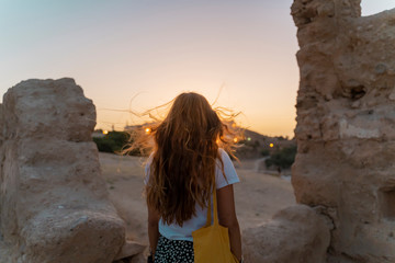 Back view of redheaded woman watching sunset, Fez, Morocco