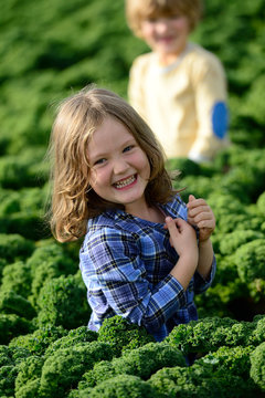 Smiling girl and boy in a kali field