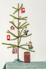 Small artificial Christmas tree with ornaments portrait