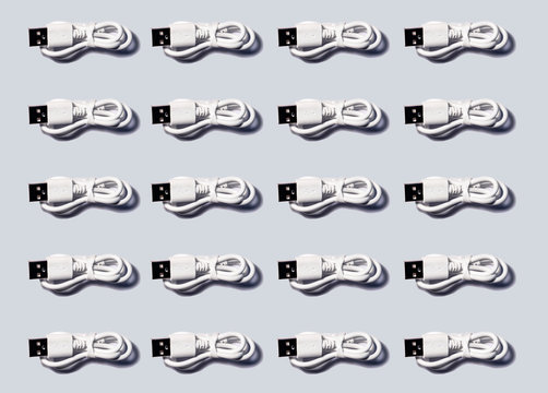 3D Illustration, white USB cables in a row on gray background