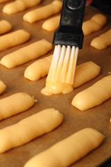 Brush pastry with egg glaze. Making Eclair.