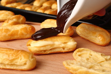 Pouring melted chocolate. Making Eclair.