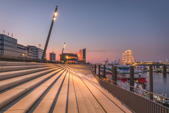 Germany, Hamburg, Steps by river and Elbphilharmonie in distance at dusk
