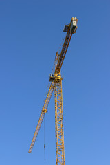 yellow crane against blue sky