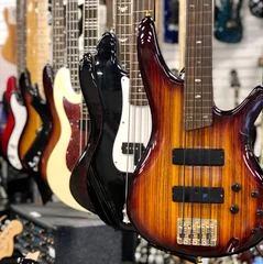 Wall murals Close view of row of electric guitars on display at a music store