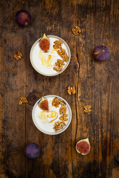 Bowls of Greek yogurt with honey, walnuts and fig
