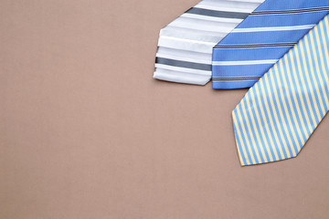 Colorful neckties on brown background