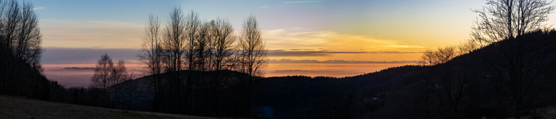High resolution stitched panorama of a beautiful sunset with the distant alps in the background near Daxstein, Bavarian forest, Bavaria, Germany