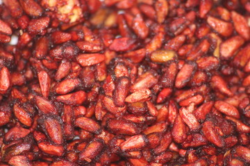 Dry red granat spice seeds  macro as background