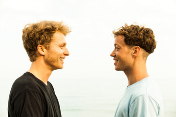 Portrait of strawberry blonde young men, face to face