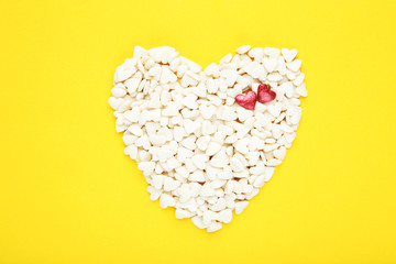 Heart shaped sprinkles on yellow background