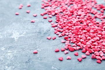 Heart shaped sprinkles on grey background