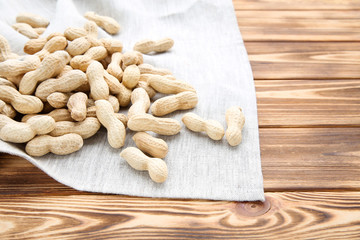 Peanuts with napkin on brown wooden table