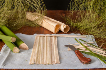The making of papyrus paper: Strips obtained from the stem of the plant with a typical knife and...