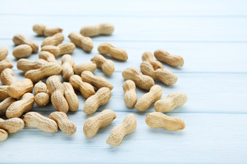 Peanuts in shell on wooden table