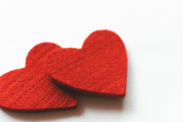 Red felt hearts on a white background. Valentine's Day