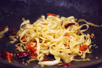 Delicious, Tasty, Hot and Spicy Traditional Asian Thai Pan Fried Fettuccine Pasta Noodle serve in luxury restaurant. Fusion Pasta Dish, Gastronomy, Delicacy, Cuisine, Dinner an Oriental Recipe concept