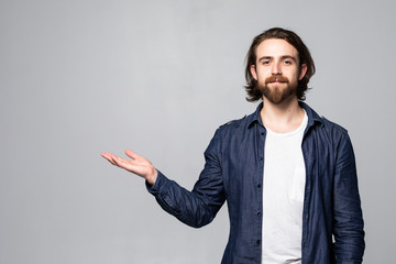 Young man hold hand present ads promo in his palms real promoter wear casual style isolated over grey color background