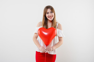 attractive woman with red heart shaped balloon isolated over white background