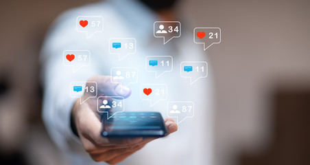 man hand using smartphone with colorful application icons around