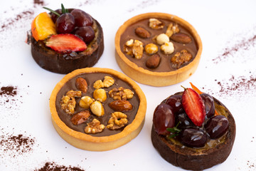 Fruit and nut cakes on warm color background, tasty and bright dessert. High angle view, color...