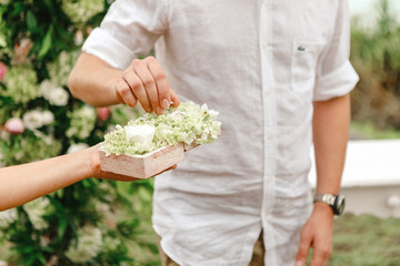 Detail of the moment when the groom takes his wedding ring to exchange it with the bride at the altar